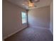 Bedroom with neutral carpet, ceiling fan and a single window offering neighborhood views at 14383 Coyote Ridge Dr, Noblesville, IN 46060