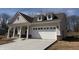 Charming single-story home with inviting front porch, attached garage, and a well-lit driveway at 14383 Coyote Ridge Dr, Noblesville, IN 46060