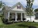 Beautiful single-Gathering home with a welcoming red door, a covered front porch, and a perfectly manicured lawn at 14383 Coyote Ridge Dr, Noblesville, IN 46060