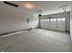 Spacious garage with a white garage door and concrete flooring at 14383 Coyote Ridge Dr, Noblesville, IN 46060