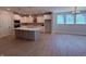 Modern kitchen featuring white cabinets, stainless steel appliances, an island, and hardwood floors at 14383 Coyote Ridge Dr, Noblesville, IN 46060