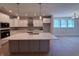 Modern kitchen features a large island, stainless steel appliances, and ample white cabinetry at 14383 Coyote Ridge Dr, Noblesville, IN 46060