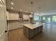 Open-concept kitchen with stainless steel appliances, white cabinets, a kitchen island, and lots of natural light at 14383 Coyote Ridge Dr, Noblesville, IN 46060