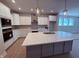 Modern kitchen features a large island, stainless steel appliances, and ample white cabinetry at 14383 Coyote Ridge Dr, Noblesville, IN 46060