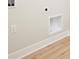 Laundry room showcasing hookups, electrical outlets, and neutral walls over wood-look flooring at 14383 Coyote Ridge Dr, Noblesville, IN 46060