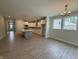 Open living area with wood flooring, white kitchen, and bright natural light at 14383 Coyote Ridge Dr, Noblesville, IN 46060