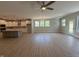 Open-concept living space featuring wood floors, kitchen island, and natural light at 14383 Coyote Ridge Dr, Noblesville, IN 46060