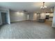 Open-concept living room with wood flooring flowing into the adjacent kitchen at 14383 Coyote Ridge Dr, Noblesville, IN 46060