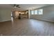 Spacious living area with wood-look floors open to kitchen with large windows at 14383 Coyote Ridge Dr, Noblesville, IN 46060