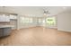 Spacious living room featuring light-colored walls, hardwood floors, large windows, and a ceiling fan at 14383 Coyote Ridge Dr, Noblesville, IN 46060