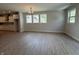 Bright living room featuring wood-look floors, natural light, and a view of the kitchen at 14383 Coyote Ridge Dr, Noblesville, IN 46060