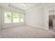 Spacious bedroom with plush carpet, large windows, trey ceilings, and an ensuite bathroom entrance at 14383 Coyote Ridge Dr, Noblesville, IN 46060
