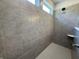 Tiled shower with built-in niche, window, and modern fixtures at 14383 Coyote Ridge Dr, Noblesville, IN 46060