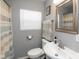 Bright bathroom features a shower, toilet, sink, and a stylish striped shower curtain at 1459 E Lynn Dr, Indianapolis, IN 46202