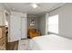 Cozy bedroom with grey walls, ceiling fan, plush armchair and closet with white paneled doors at 1459 E Lynn Dr, Indianapolis, IN 46202