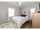 Cozy bedroom features wood-look flooring, white bedding, and a ceiling fan at 1459 E Lynn Dr, Indianapolis, IN 46202