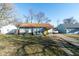Inviting single-story home with a cozy front porch, updated roof, and convenient driveway parking at 1459 E Lynn Dr, Indianapolis, IN 46202