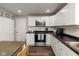 Modern kitchen featuring white cabinets, stainless steel appliances, and sleek countertops at 1459 E Lynn Dr, Indianapolis, IN 46202