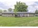 Spacious backyard with lush green grass and a charming stone-exterior home at 1459 S Josephine St, Martinsville, IN 46151
