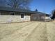 Expansive backyard showcasing the home's stone exterior and mature trees at 1459 S Josephine St, Martinsville, IN 46151