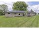 Expansive backyard featuring a stone-clad home and a well-manicured lawn at 1459 S Josephine St, Martinsville, IN 46151