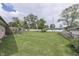 Wide backyard with expansive green lawn, framed by trees and a wood fence at 1459 S Josephine St, Martinsville, IN 46151