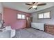 Well-lit bedroom with neutral walls, a large window, and a set of wooden dressers at 1459 S Josephine St, Martinsville, IN 46151