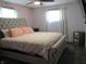 Comfortable bedroom featuring a cozy bed, soft lighting, and a ceiling fan, perfect for restful nights at 1459 S Josephine St, Martinsville, IN 46151