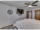 Modern bedroom showing a wall-mounted TV, hardwood floors, a ceiling fan, and open closet at 1459 S Josephine St, Martinsville, IN 46151