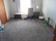 Bright bedroom featuring a cozy seating area by the window and a gray plush carpet at 1459 S Josephine St, Martinsville, IN 46151