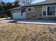 Charming home with a white garage door, stone facade, and newly installed concrete driveway at 1459 S Josephine St, Martinsville, IN 46151