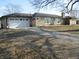 Ranch style home featuring a large garage and well-manicured landscaping at 1459 S Josephine St, Martinsville, IN 46151