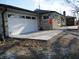 Single story home with white garage door, adjacent concrete patio and stone veneer facade at 1459 S Josephine St, Martinsville, IN 46151
