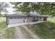 Beautiful stone ranch-style house features a two-car garage, stone facade, and mature trees at 1459 S Josephine St, Martinsville, IN 46151