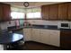 Functional kitchen with white and wood cabinets, laminate countertops, and a stainless steel sink at 1459 S Josephine St, Martinsville, IN 46151