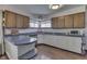 Bright kitchen offering wood-trimmed cabinets, neutral countertops, modern appliances, and light-colored floors at 1459 S Josephine St, Martinsville, IN 46151