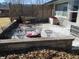 Spacious patio with lattice fencing, outdoor seating, and a stone retaining wall at 1459 S Josephine St, Martinsville, IN 46151