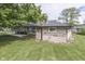A stone-sided ranch-style home with a well-maintained yard and an open side lawn at 1459 S Josephine St, Martinsville, IN 46151