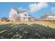 Backyard featuring a home with a sunroom, lush green lawn, and blue sky above at 14936 Newport Dr, Westfield, IN 46074