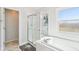 Bathroom featuring a separate shower, a soaking tub, a window, and tiled floors at 14936 Newport Dr, Westfield, IN 46074
