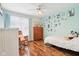 Brightly decorated bedroom with hardwood floors, a rocking chair and ample natural light at 14936 Newport Dr, Westfield, IN 46074