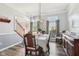 Bright dining room showcasing hardwood floors and decor, seamlessly blending classic charm with modern elegance at 14936 Newport Dr, Westfield, IN 46074