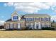 Charming brick home featuring gray shutters, a manicured lawn, and an inviting entrance with white columns at 14936 Newport Dr, Westfield, IN 46074
