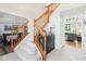 Inviting foyer with a staircase and hardwood floors, leading into an open-concept living space at 14936 Newport Dr, Westfield, IN 46074