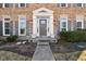 Elegant front entrance with white columns, sidelights, and a gray front door, framed by lush landscaping at 14936 Newport Dr, Westfield, IN 46074