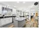 Open kitchen with white cabinets, granite counters, stainless appliances, and central island at 14936 Newport Dr, Westfield, IN 46074