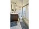 Well-lit bathroom with dark wood vanity, white fixtures, and a glass-enclosed shower at 1505 S Alabama St, Indianapolis, IN 46225