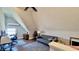 Bright, sloped ceiling bonus room with hardwood floors, a sofa, and an AC unit at 1505 S Alabama St, Indianapolis, IN 46225