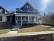 Charming two-story home with a covered front porch and well-maintained lawn at 1505 S Alabama St, Indianapolis, IN 46225