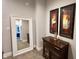 A hallway with carpet flooring, a console table, and a mirror at 1505 S Alabama St, Indianapolis, IN 46225